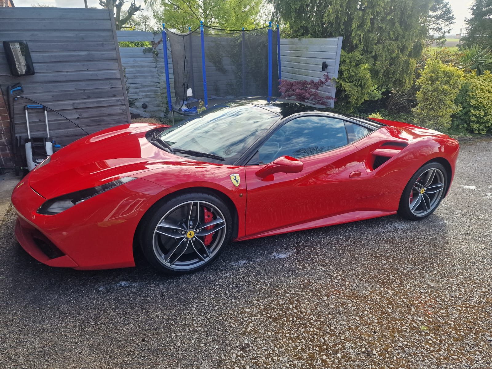 Red Ferrari 488 prepared for enclosed collection