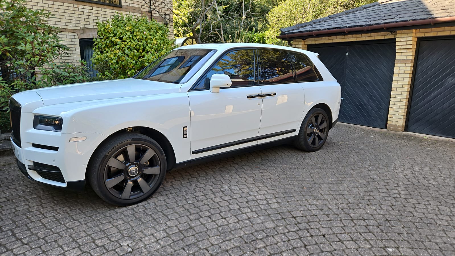 White Rolls-Royce Cullinan on a private driveway