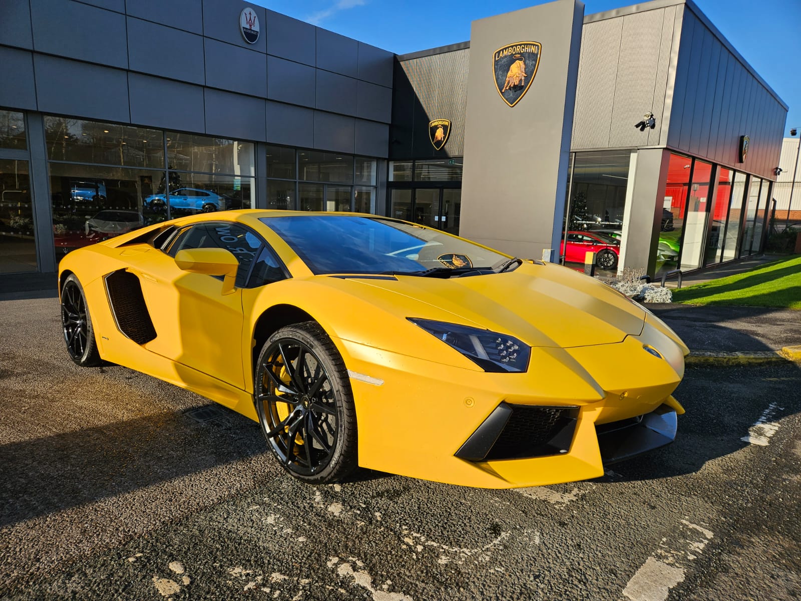 Yellow Lamborghini Aventador at a supercar showroom